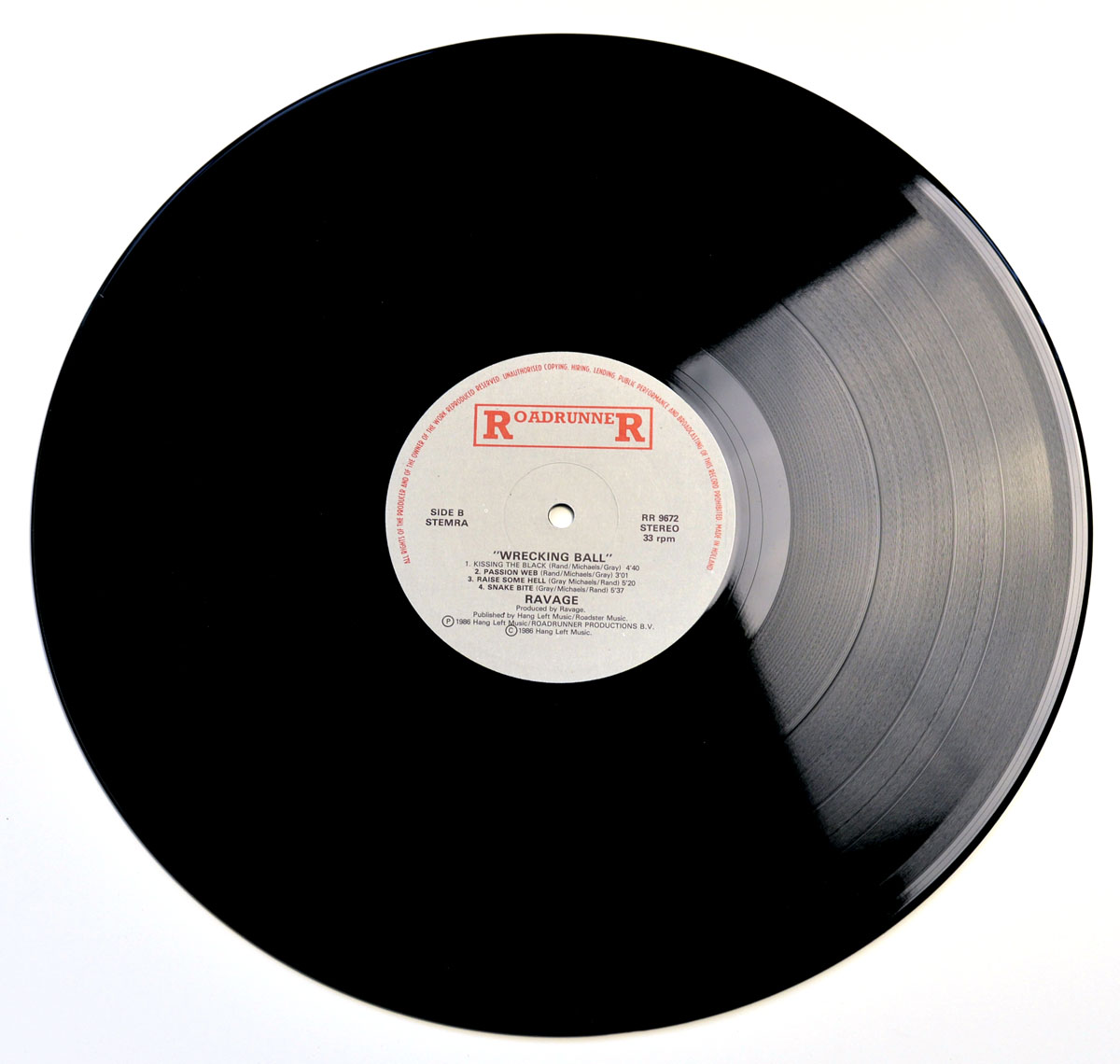 Side B label of the 1986 RAVAGE - Wrecking Ball LP on Roadrunner Records showing tracklist, catalog number RR 9672, and publishing details on a white label